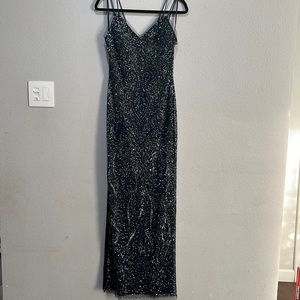 Navy blue sequin gown with side slit.